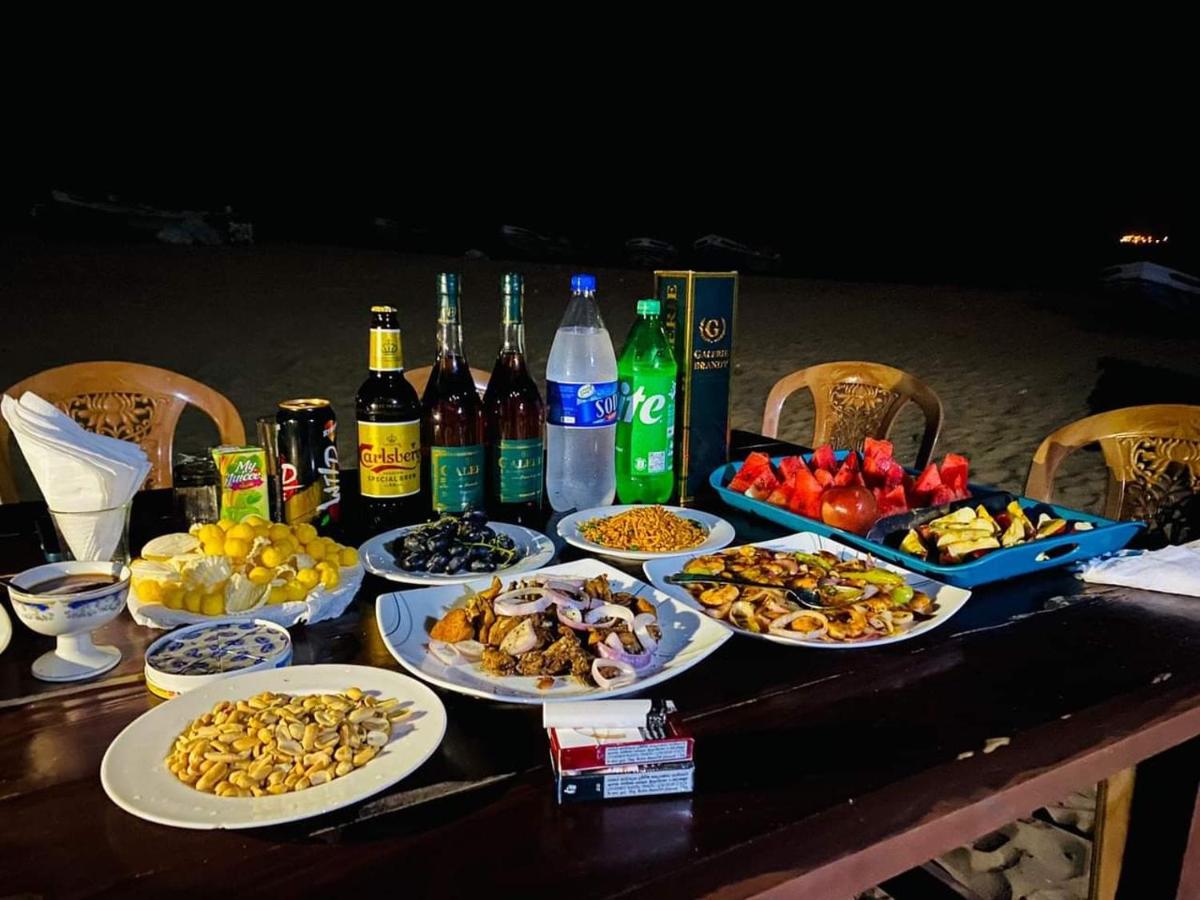 Tables with plates of food and drinks ready for an evening dinner