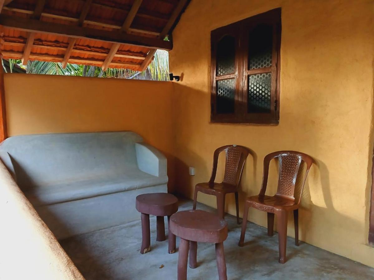 Covered porch with relaxing chairs overlooking the garden and sea