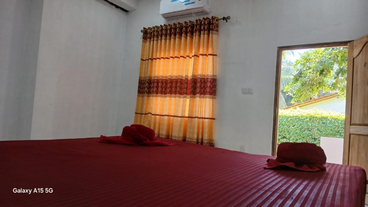 Cozy deluxe bedroom with red linens and garden window view